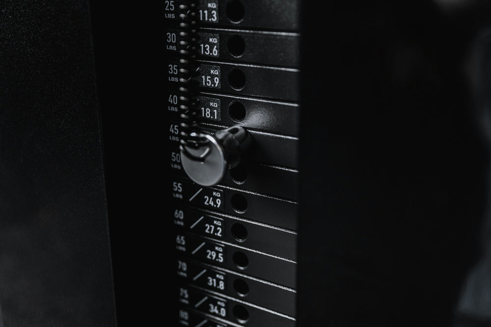 Close-up shot of one of the weight stacks and magnetized pin for the Arcadia™ max