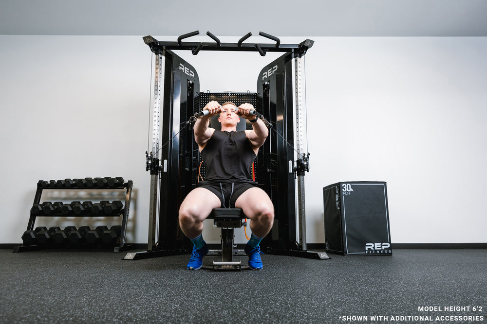 Image of someone on a bench in front of the black Arcadia™ max doing a seated chest press