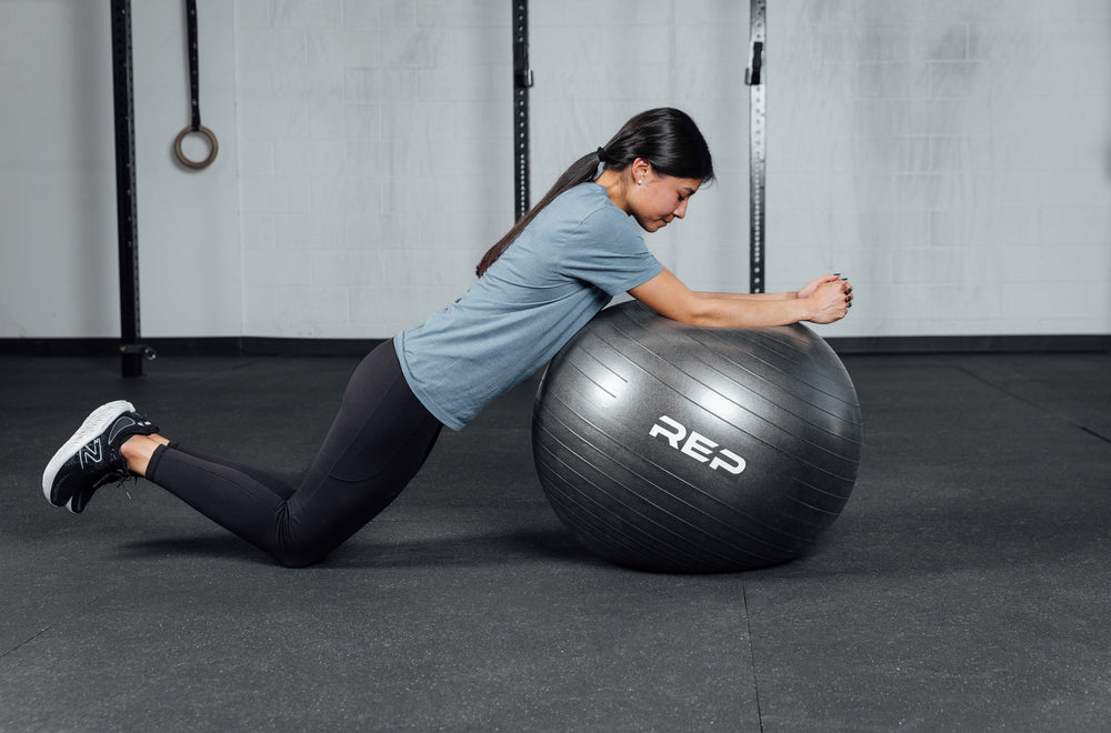 An athlete doing ball roll outs with the REP Physioball