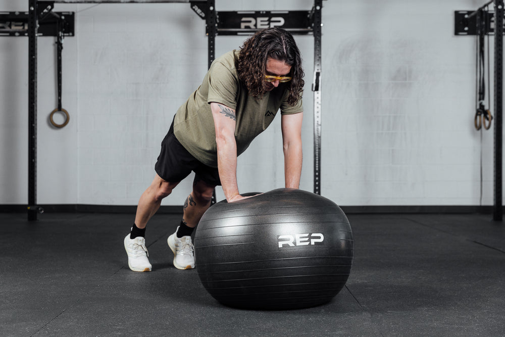 An athlete performs push ups on the Physioball.