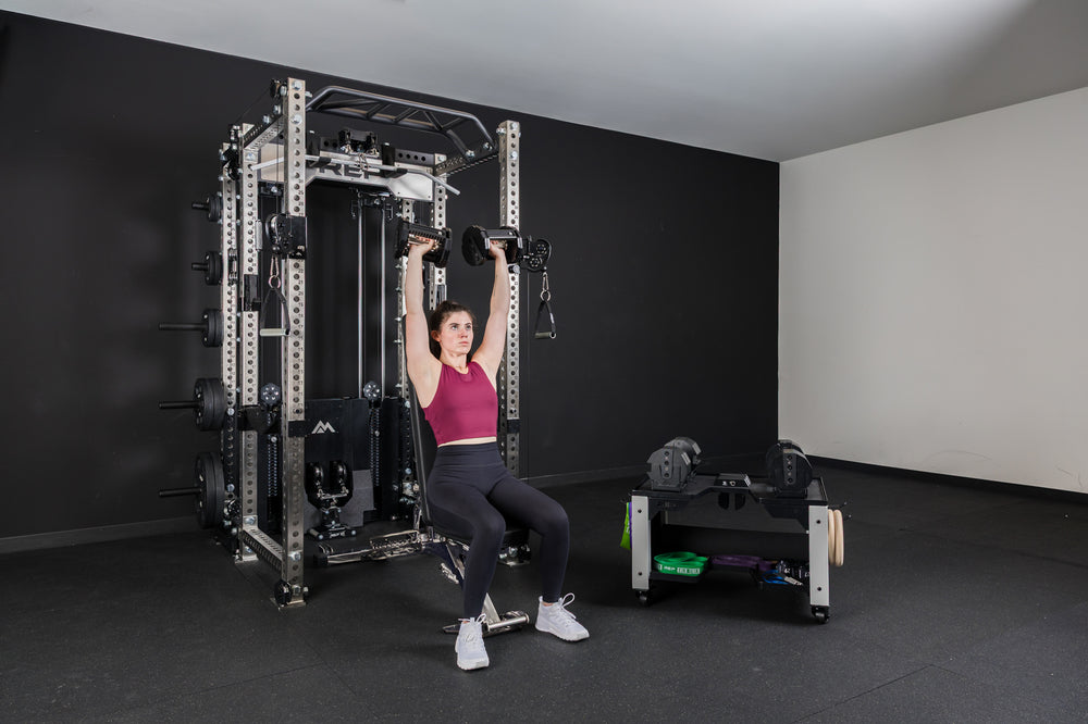 An athlete doing seated shoulder presses with the REP® x PÉPIN™ FAST Series™ Adjustable Dumbbell