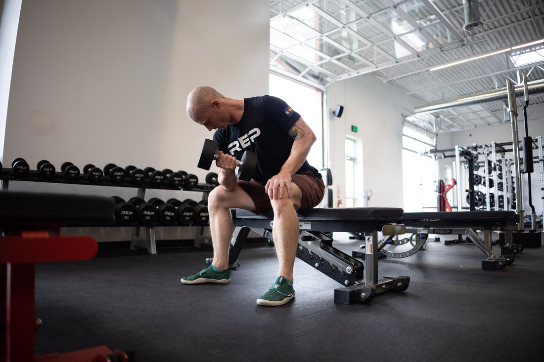 Man doing curls in gym