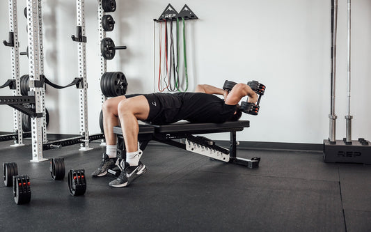 Man performs dumbbell skull crusher triceps extentions.
