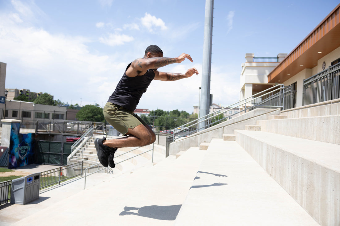 Athlete jumps up stairs in the sun.