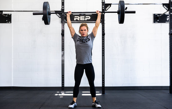 Lifter doing an overhead press with a barbell