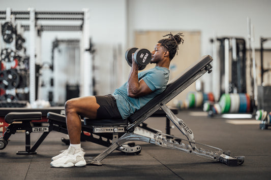 Man doing incline curls