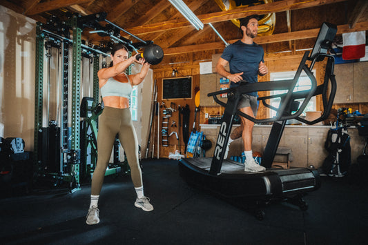 Athletes work with a REP kettlebell and the Strive™ Curved Treadmill.