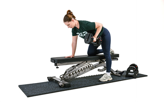 Woman lifting on gym flooring