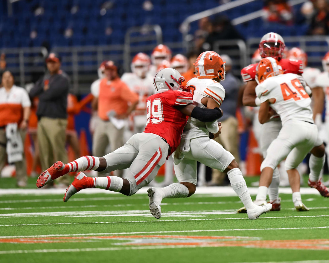 Football player makes a tackle during a game.