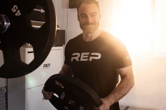 Man loading plates on a barbell