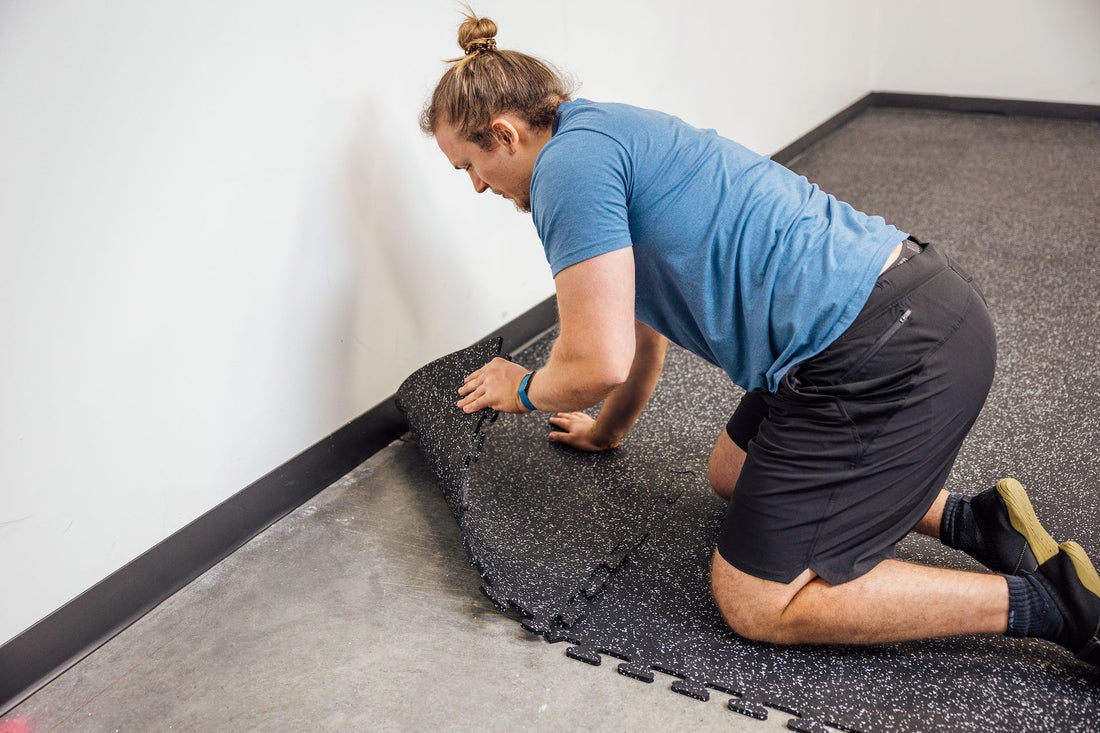 Lifter installing gym flooring