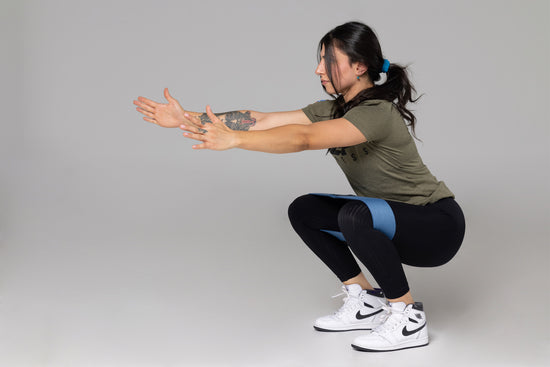 Lifter doing squats with bands