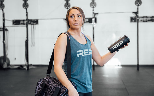 Woman with a protein shaker cup