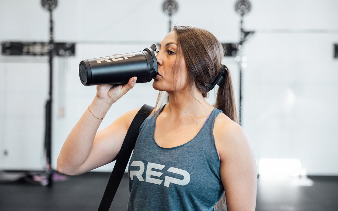 Woman drinking from an ice shaker