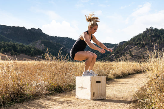 Woman jumping on a plyo box