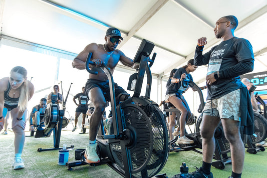 Athlete works on the Strive™ Air Bike during the Phorm Energy Training Camp Powered by REP.