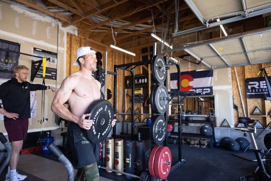 Lifter rereacking weight plates in his home gym