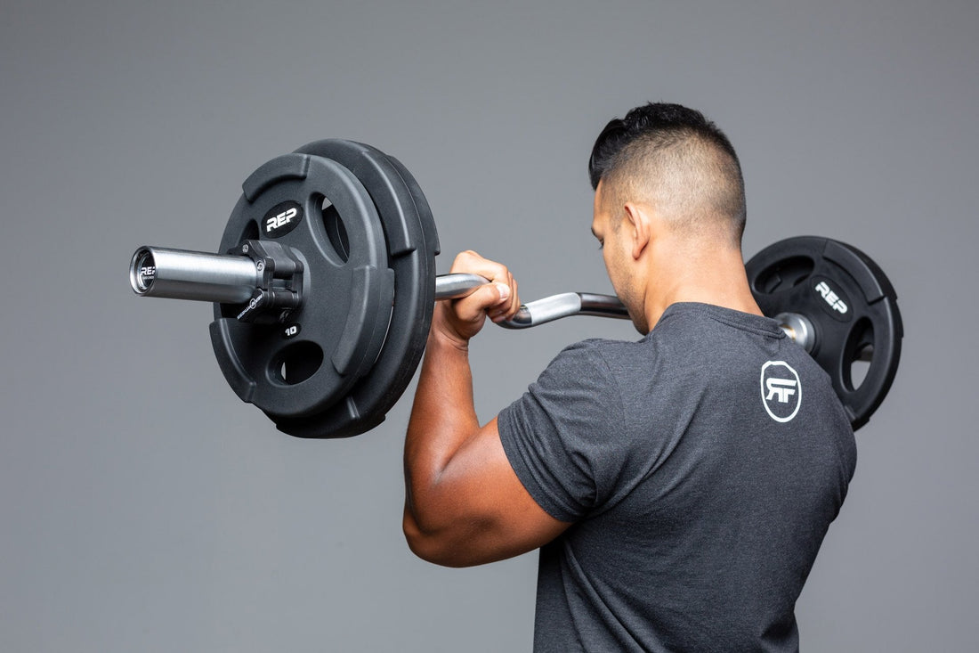 Athlete curls the REP EZ Curl Bar.