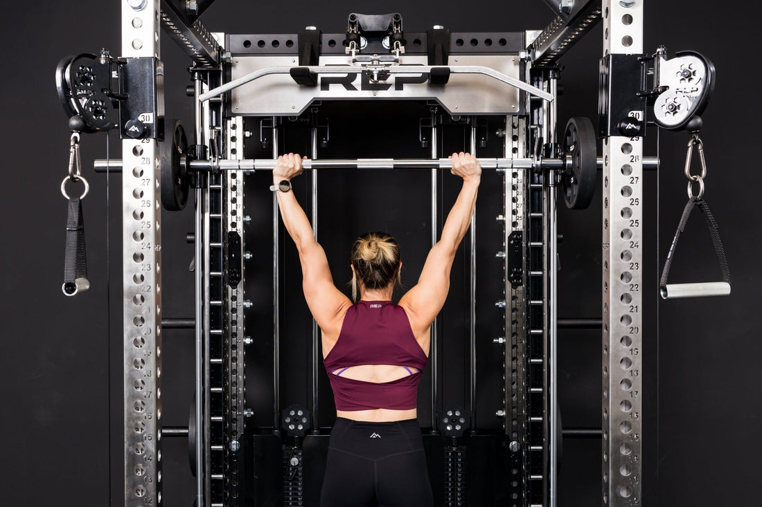 An athlete presses overhead using the REP® Smith Machine attachment.
