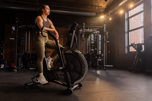 Athlete rests after a Strive™ Air Bike workout.