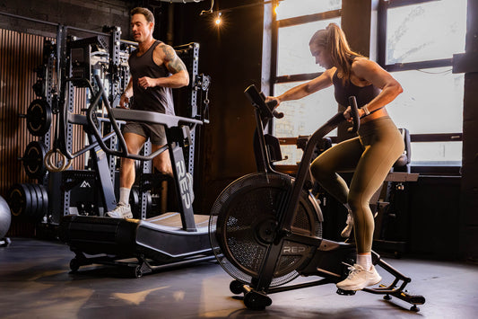 Athletes work on the Strive™ Curved Treadmill and Strive™ Air Bike featuring VPR™.