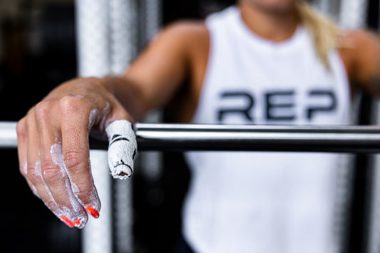 Lifter with her thumb taped