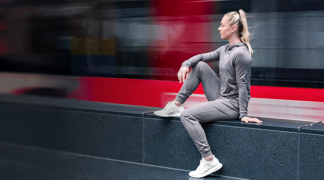 Athlete sits in Vellus Joggers and Vellus Hoodie.