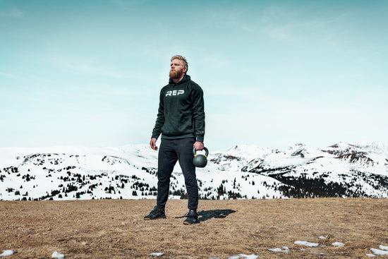 Lifter with a kettlebell on top of a mountain