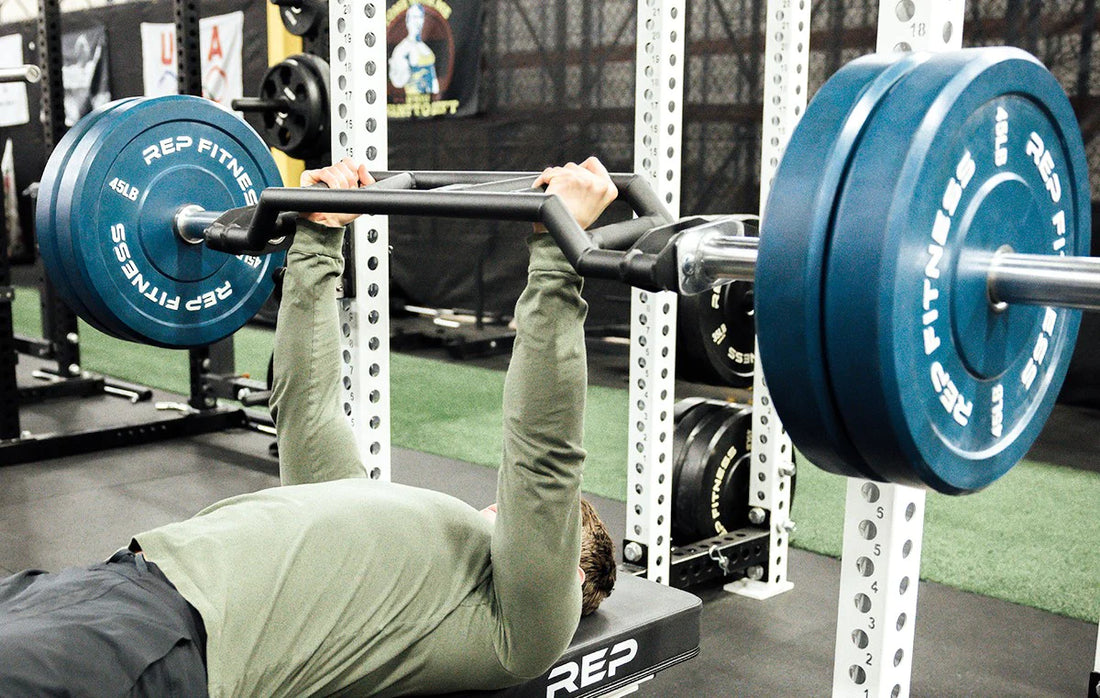 Lifter benching with a Cambered Swiss Bar