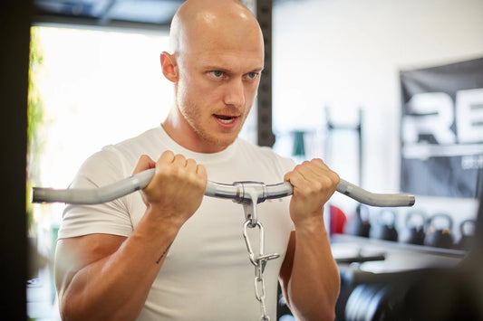 Lifter doing curls with a cable machine