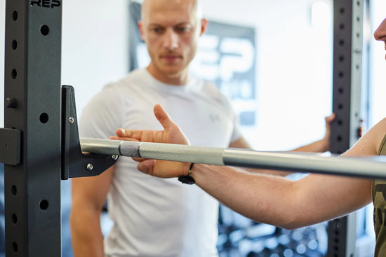 Lifters looking at a barbell