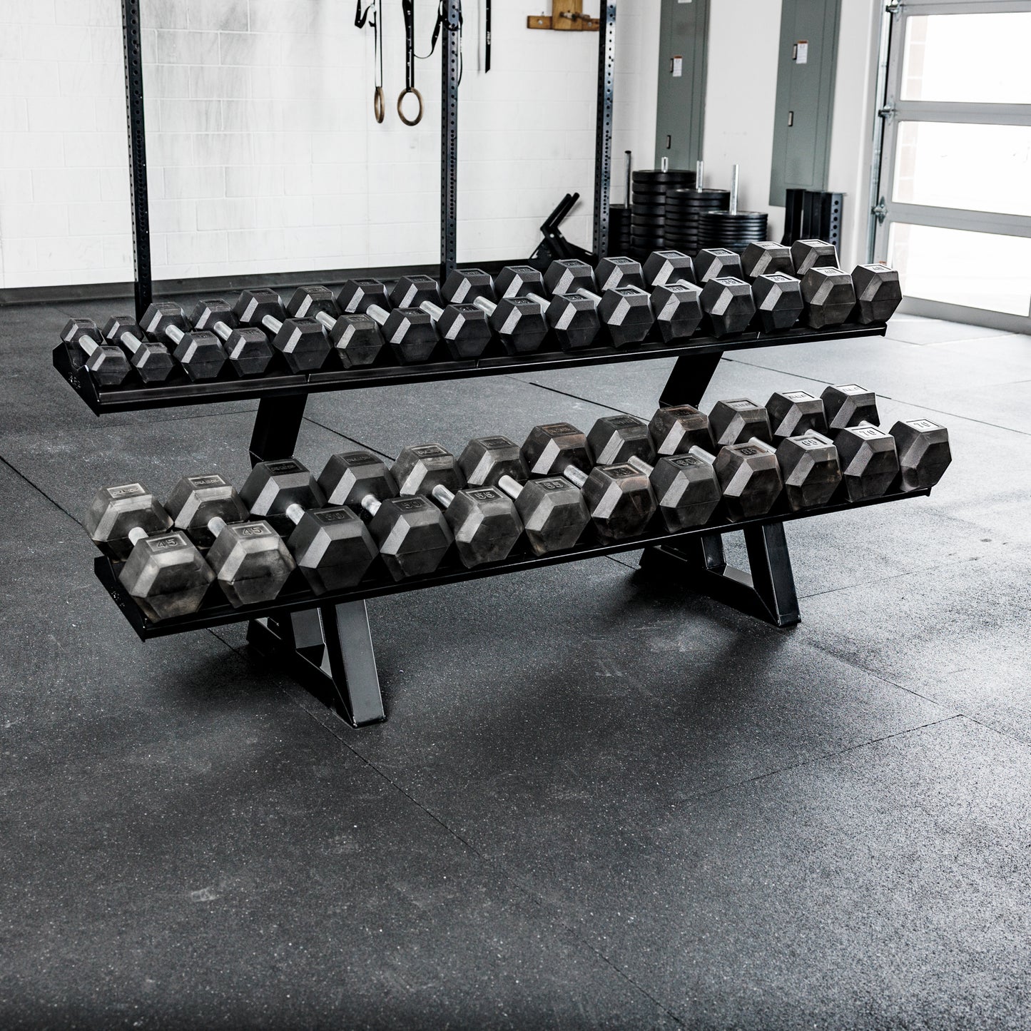 REP Fitness 2-Tier Commercial Dumbbell Rack loaded with Hex dumbbells