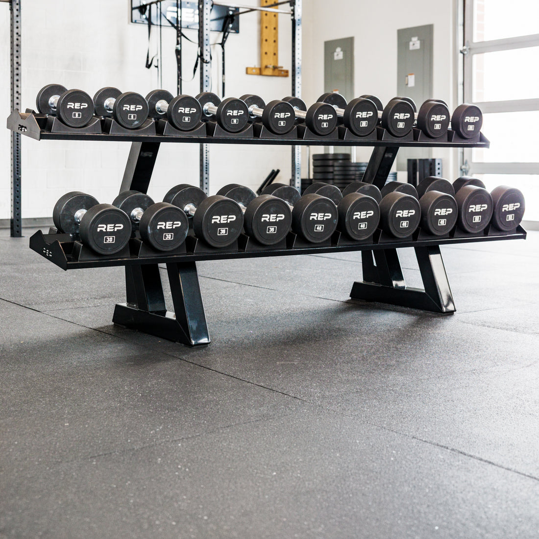 REP Fitness 2-Tier Commercial Dumbbell Rack loaded with round dumbbells