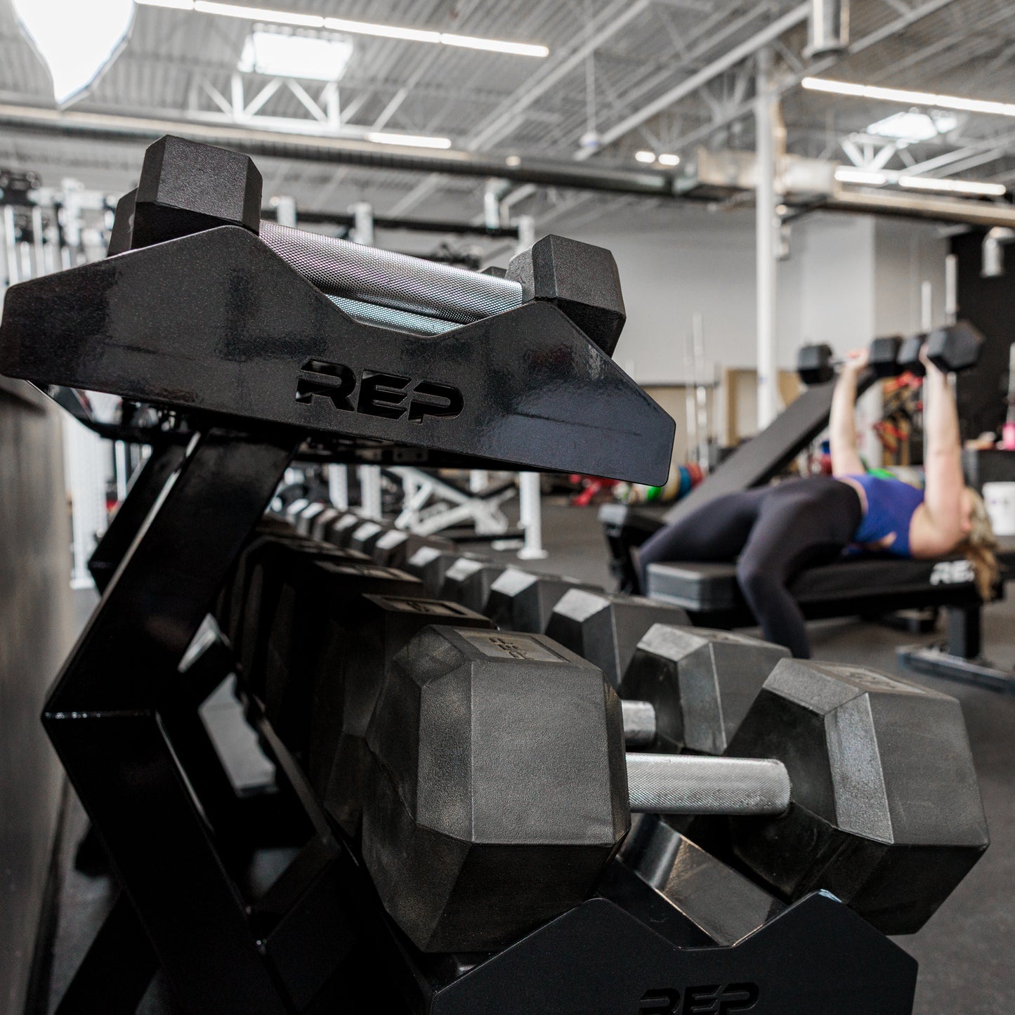 Side view of the REP Fitness Commercial Dumbbell Rack loaded with Hex dumbbells