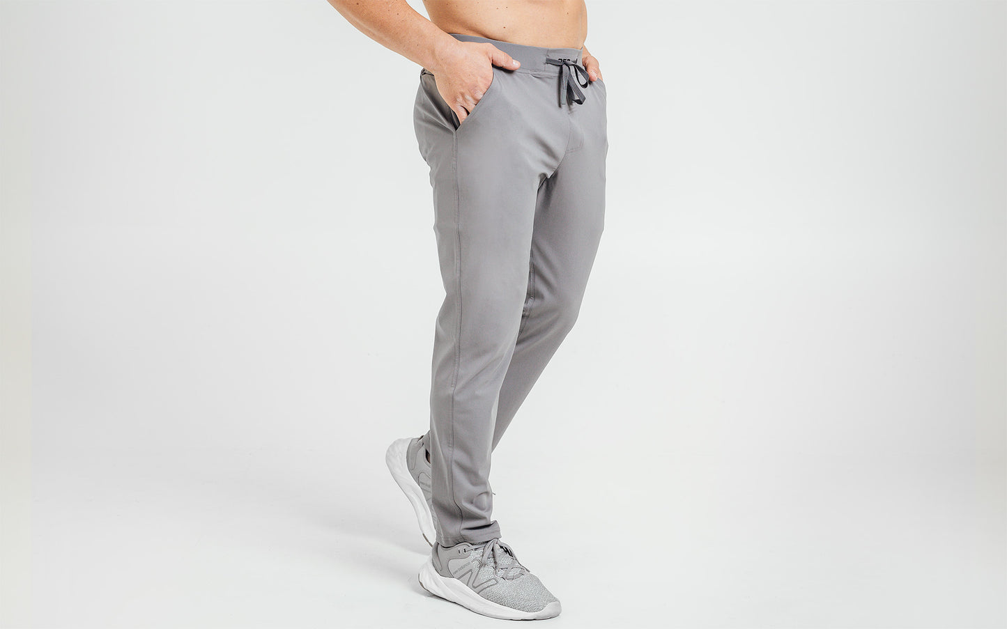 Side view of model wearing the cool gray REP Felix Pants