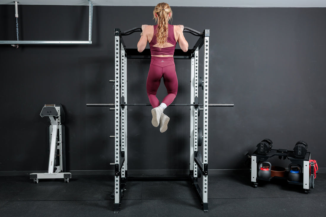 Athlete doing pull-ups on the multi-grip pull-up bar on the REP Fitness Altitude™ Power Rack