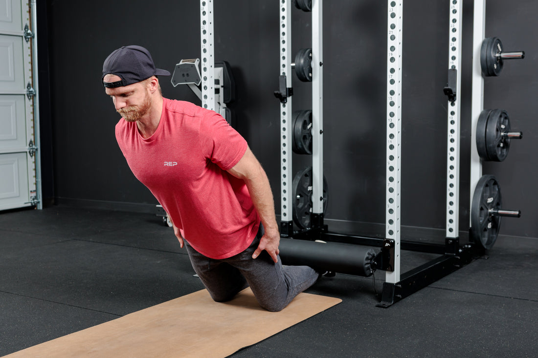 Athlete doing a Nordic Hamstring Curl with the Altitude™ Leg Roller on the Power Rack