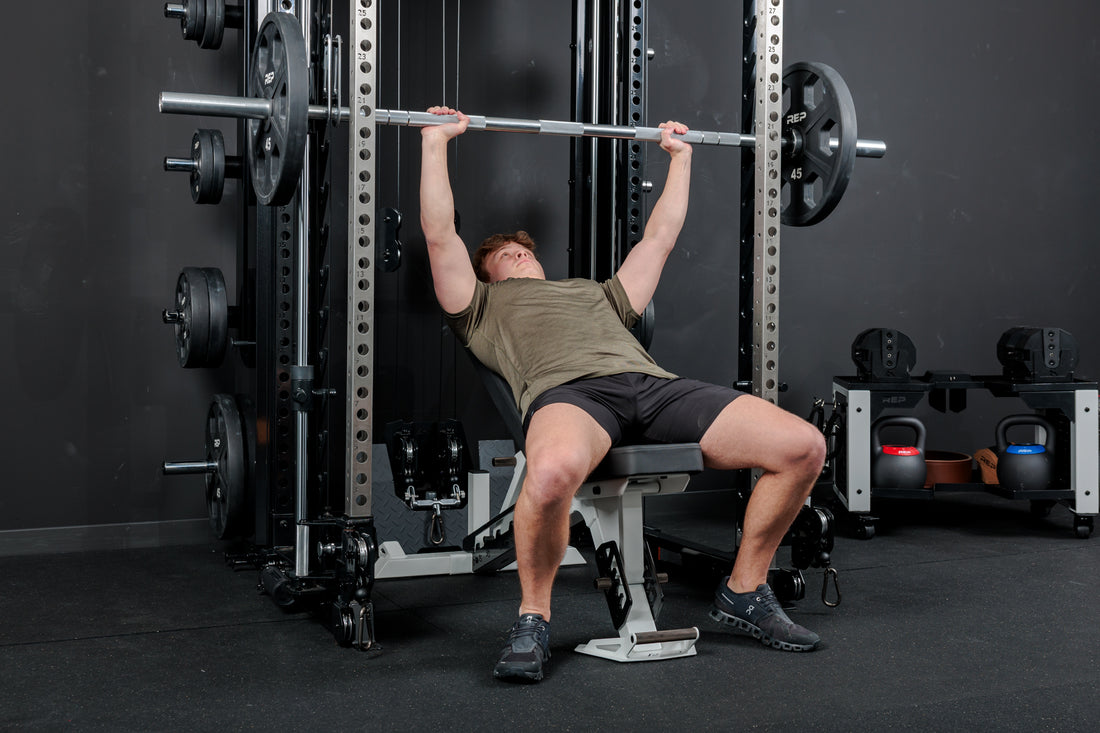 Athlete using the REP Fitness Altitude™ Power Rack Smith Machine Attachment for incline bench press