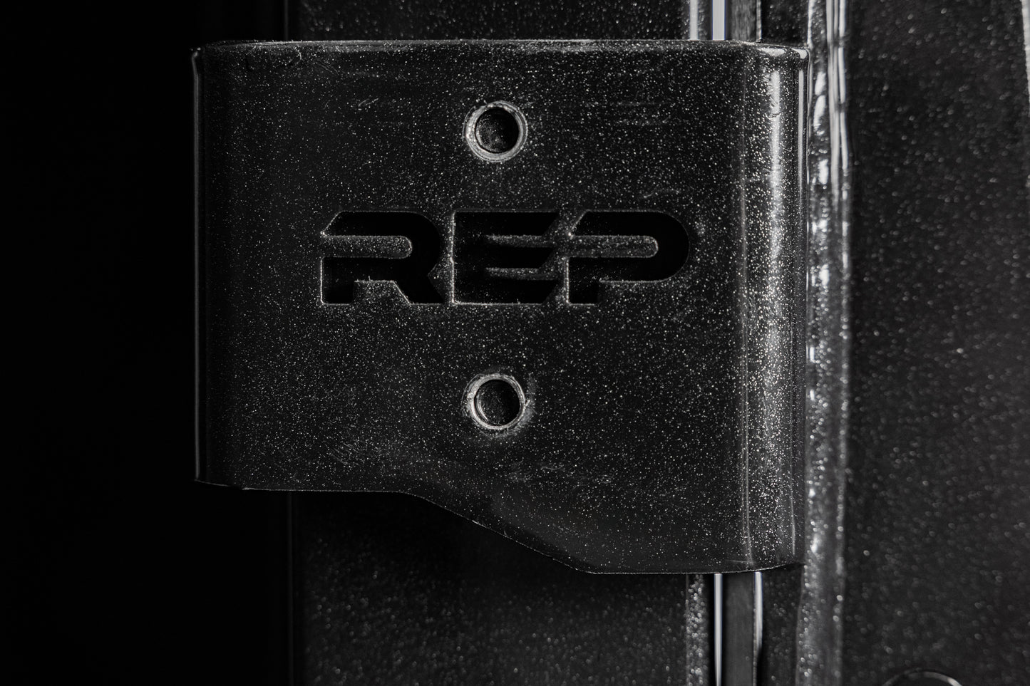 Close-up shot of the laser-cut branding on the REP Fitness Altitude™ J-Cups