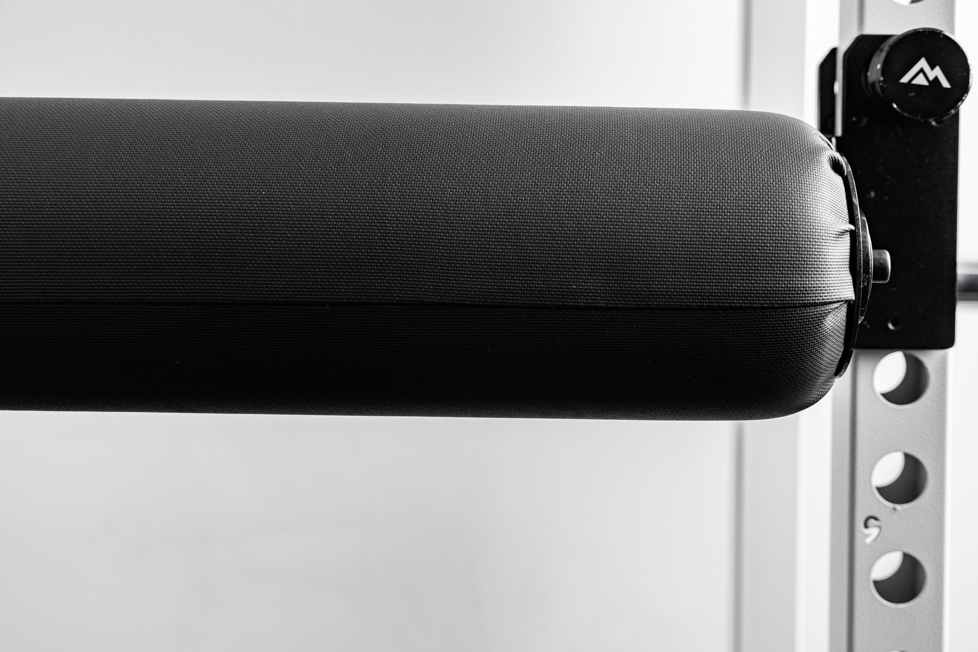 Close-up of the REP Fitness Altitude™ Leg Roller diameter compared to the mounting hardware