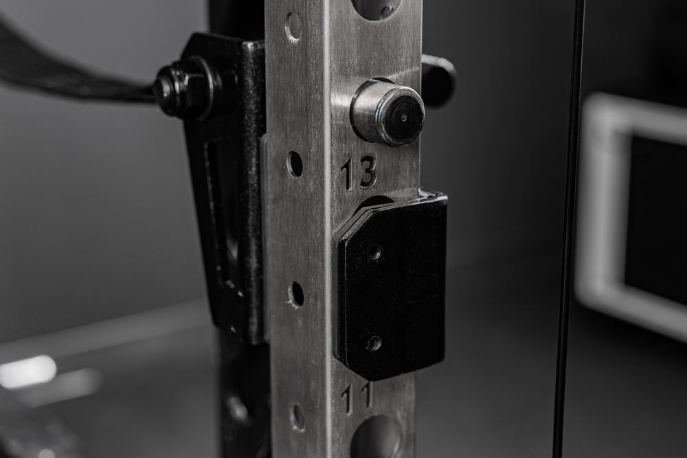 Backside of the REP Fitness Altitude™ Power Rack Strap Safeties on a rack upright