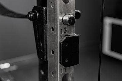 Backside of the REP Fitness Altitude™ Power Rack Strap Safeties on a rack upright
