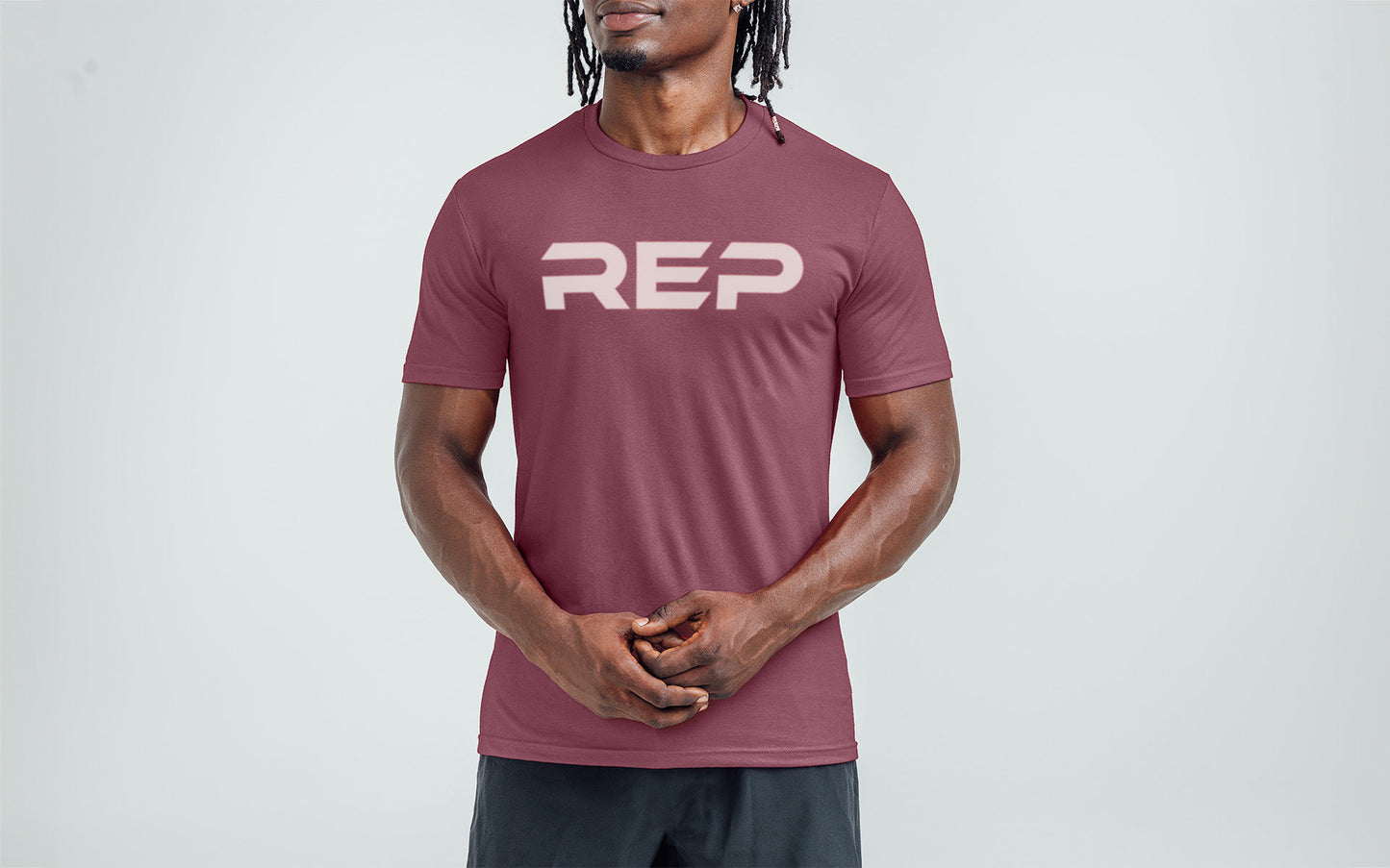 Model wearing the REP Fitness Men's Daily Driver 2.0 Tri-Blend Crew T-Shirt in Heather Maroon