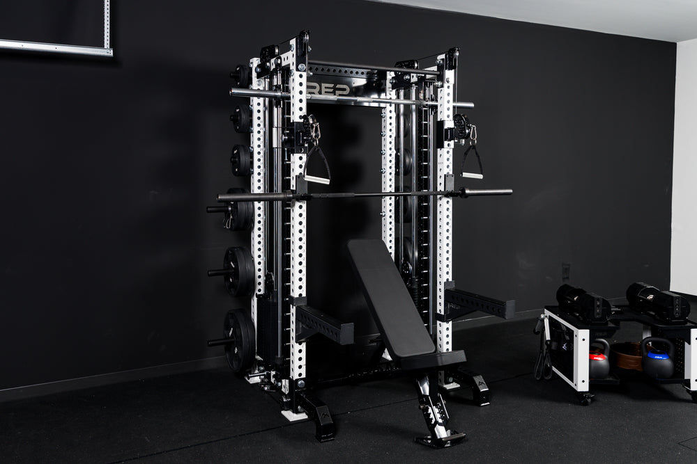 Summit™ All-In-One Athena™ Upgrade Kit showing the full setup of Summit™ All-In-One Athena™ with full gym setup with a bench, weights, a barbell, and dumbbell