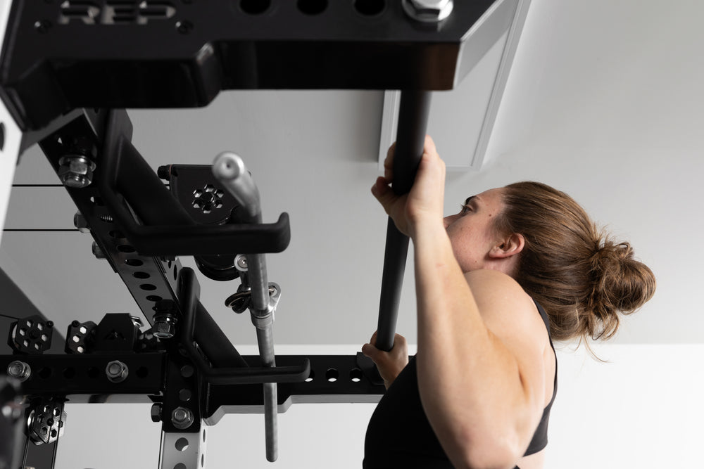 Person performing pull-ups on a pull-up bar (Ares 2.0 4-Post Pull-Up Bar + Pull-Up Bar Extension Brackets).