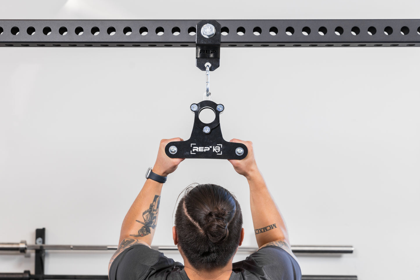 Athlete using the REP Fitness Shackle attached to a PR-5000 crossmember with a REP x Kleva Built close-grip attachment