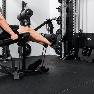 Athlete using the cable kit for cable resistance on the Leg Extension & Leg Curl Bench Attachment
