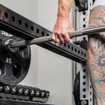 Close-up shot of an athlete rowing the barbell into the bottom of the Flip-Down Safeties 2.0