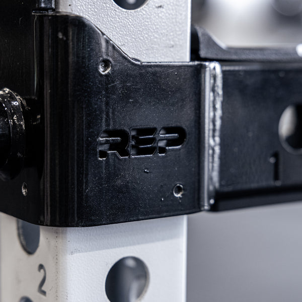 Close-up shot of the branding on the REP Fitness Flip-Down Safeties 2.0