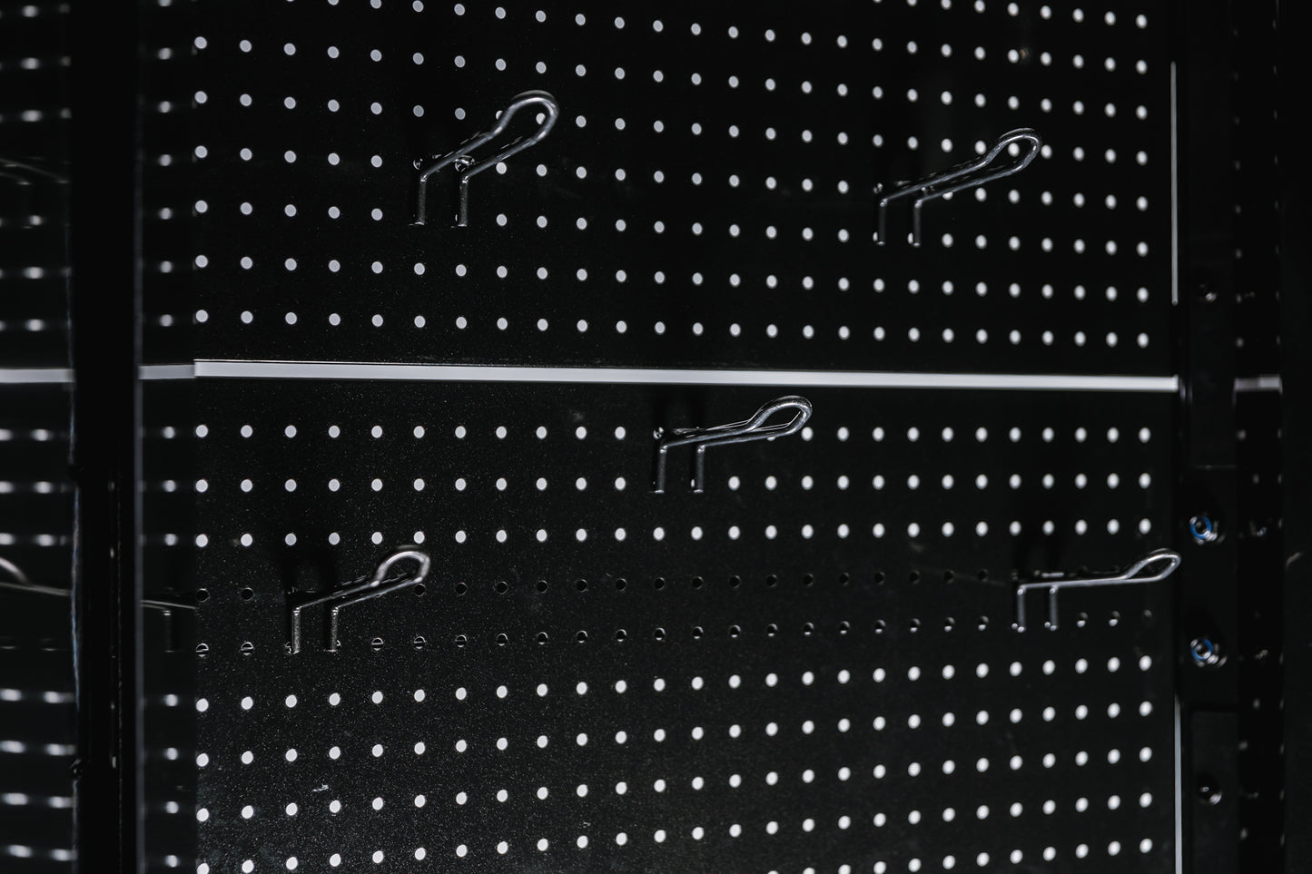 Pegboard storage hooks on a black Arcadia Max